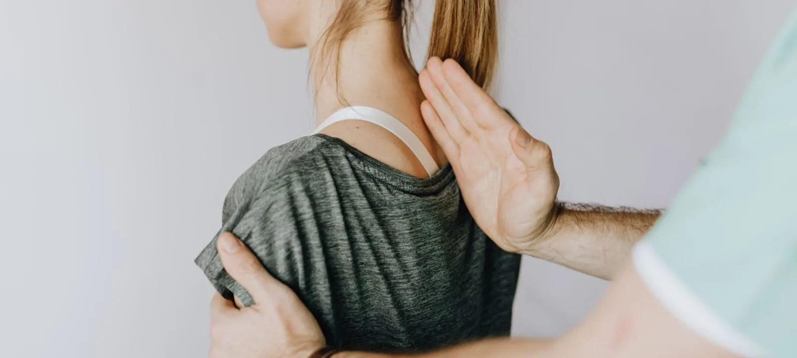 A therapist performing focused manual therapy on a patient’s shoulder